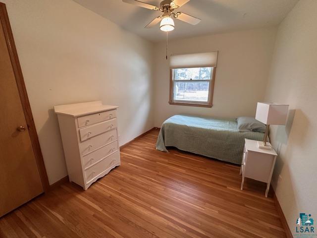 62 Elm Boulevard Babbitt, MN 55706 - Photo 10 of 21 Bedroom featuring baseboards, light wood finished floors, and ceiling fan