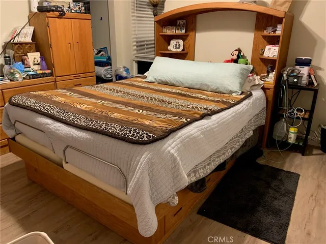 a bed sitting in a bedroom and mirror