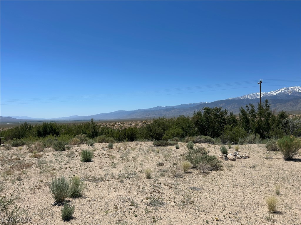 360 Mountain Creek Road Dyer, NV 89010 - Photo 3 of 23 A vast, open lot presents panoramic views of distant mountains and a clear, wide-open sky.