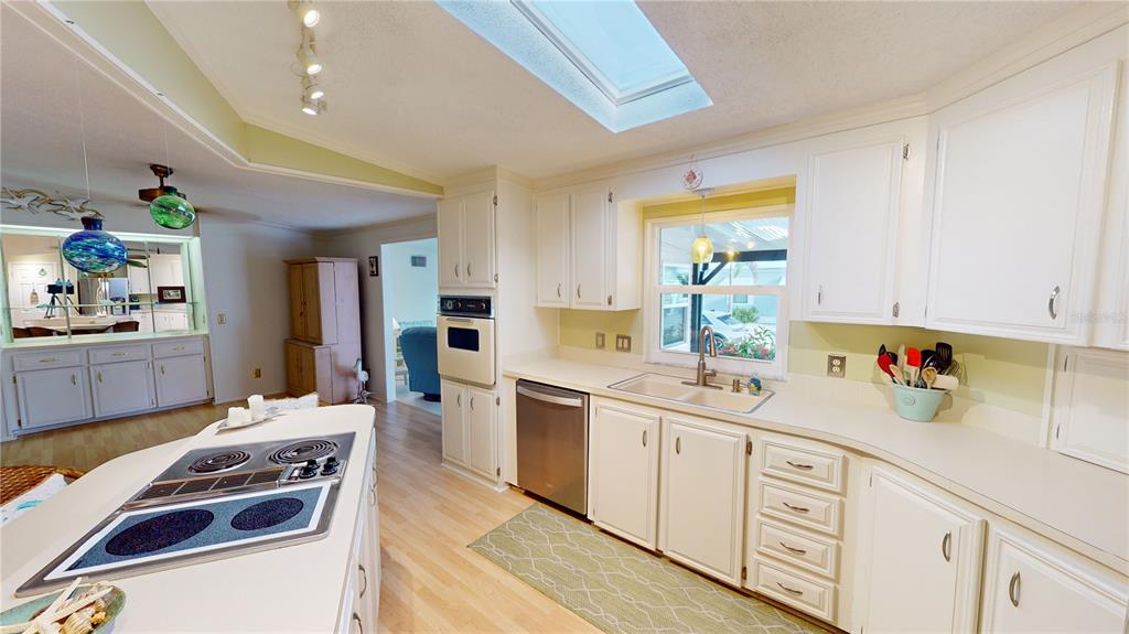 15550 Burnt Store Road, Unit 164 Punta Gorda, FL 33955 - Photo 11 of 44 a kitchen with a sink stove and cabinets