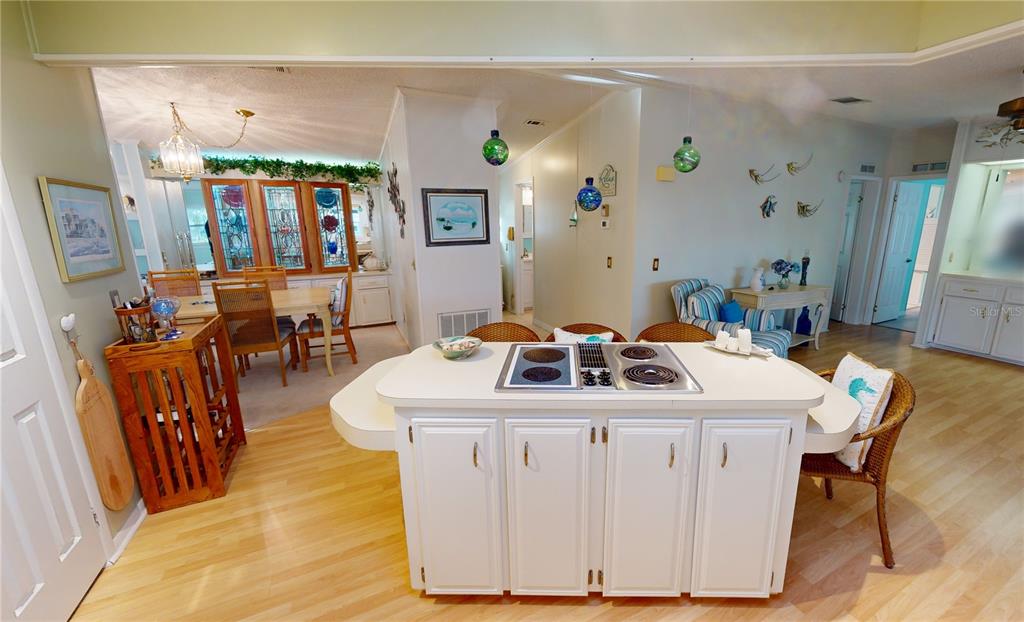 15550 Burnt Store Road, Unit 164 Punta Gorda, FL 33955 - Photo 12 of 44 a white kitchen with a table chairs and a dining table