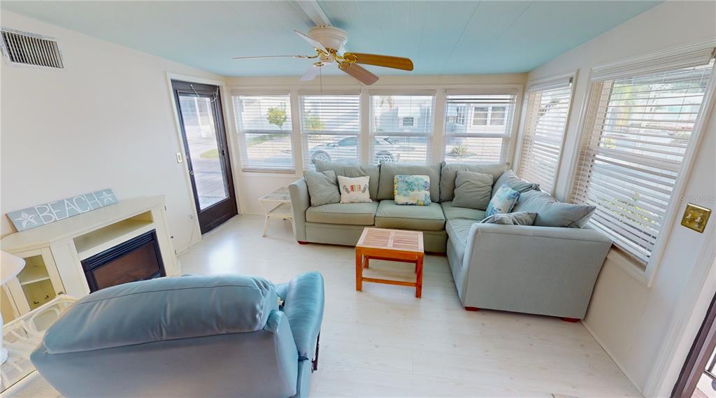 15550 Burnt Store Road, Unit 164 Punta Gorda, FL 33955 - Photo 16 of 44 a living room with furniture and a floor to ceiling window