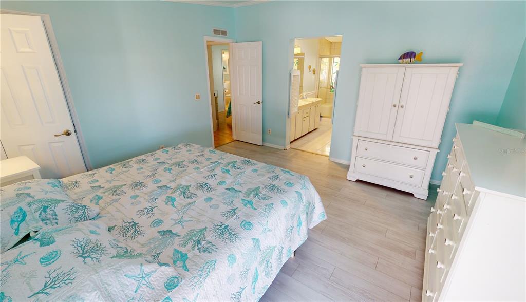 15550 Burnt Store Road, Unit 164 Punta Gorda, FL 33955 - Photo 19 of 44 a bedroom with a bed and a dresser