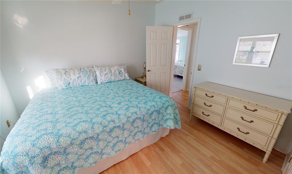 15550 Burnt Store Road, Unit 164 Punta Gorda, FL 33955 - Photo 23 of 44 a bedroom with a bed and a dresser