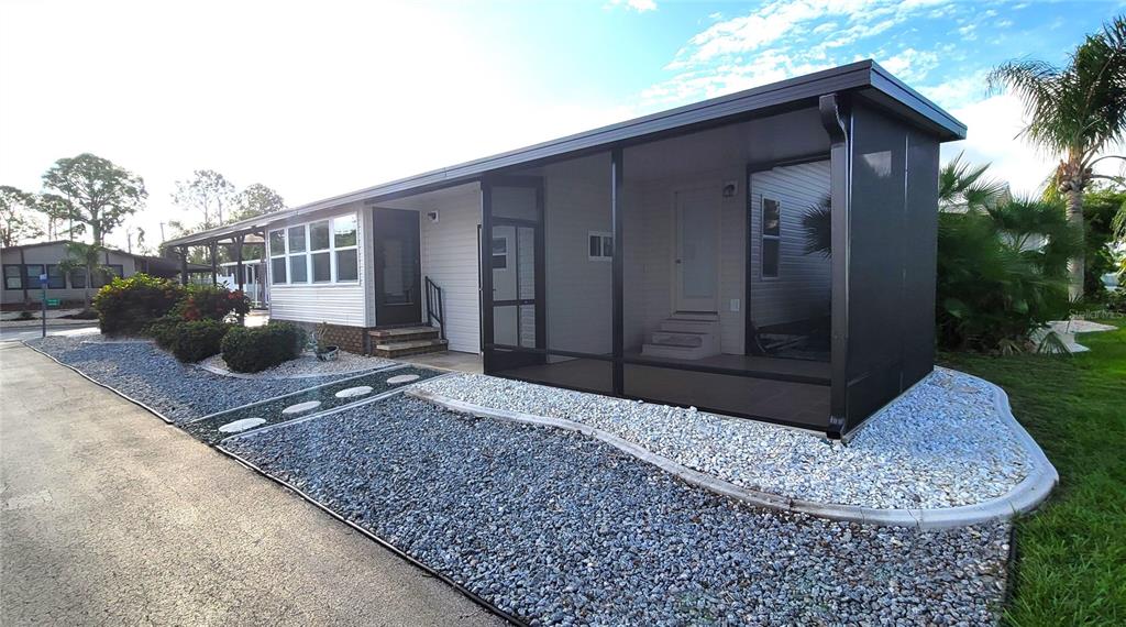 15550 Burnt Store Road, Unit 164 Punta Gorda, FL 33955 - Photo 31 of 44 a view of a house with backyard and sitting area