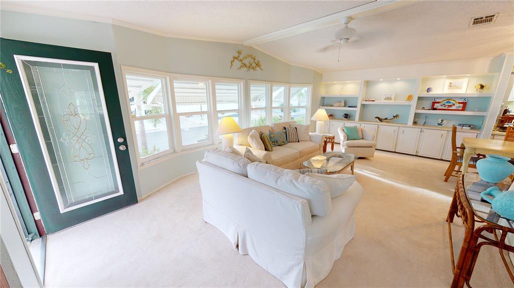 15550 Burnt Store Road, Unit 164 Punta Gorda, FL 33955 - Photo 6 of 44 a living room with furniture and a large window