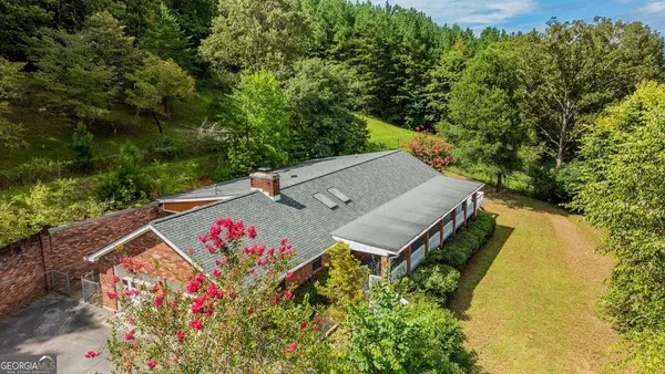 an aerial view of a house having swimming pool