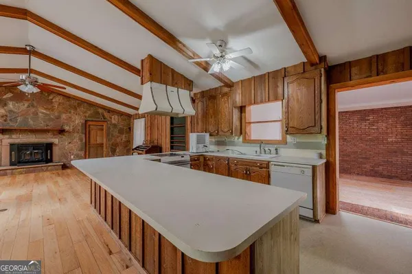 a kitchen with a stove a refrigerator and a fireplace