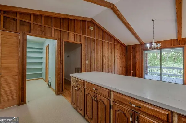 a hallway with sliding door and stairs