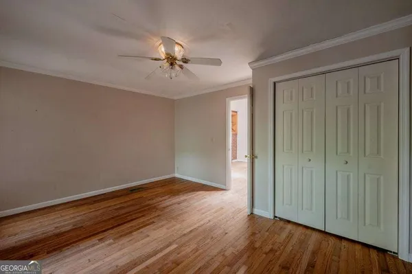 a view of room with hardwood floor and ceiling fan