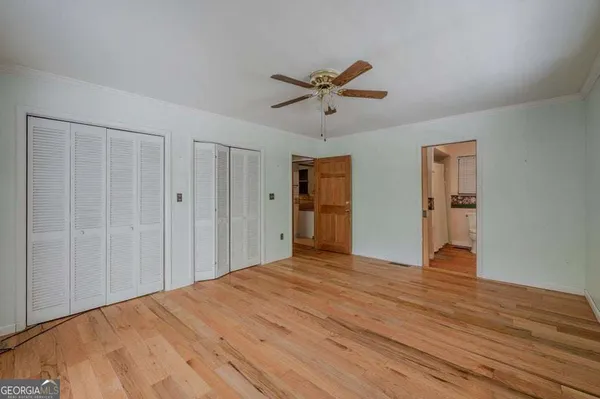 a view of empty room with wooden floor