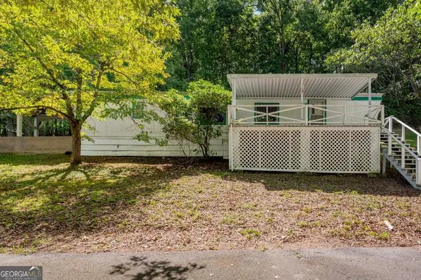 a view of a yard with wooden fence