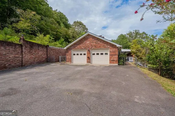 a view of a house with a yard and garage