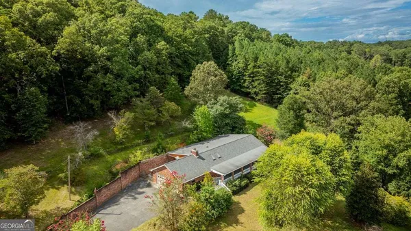 an aerial view of a house with a yard