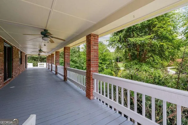 a view of a porch with wooden floor and outdoor space