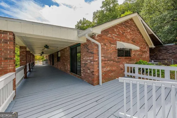 a view of house with deck and outdoor space