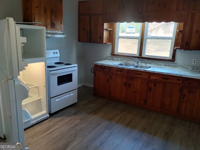 a kitchen with sink cabinets and window