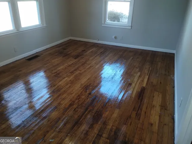 a view of wooden floor in an empty room