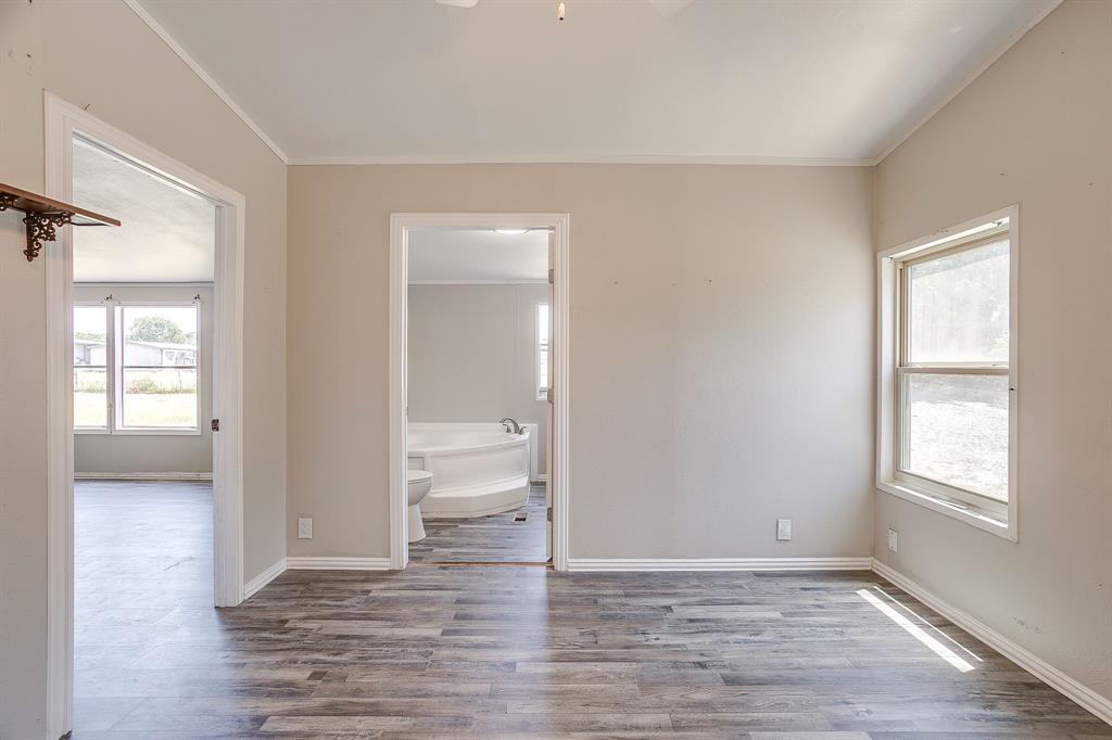 178 Valley Lake Lane Springtown, TX 76082 - Photo 19 of 33 Spacious interior room featuring wood-finish flooring, light-toned walls, and a window for natural illumination