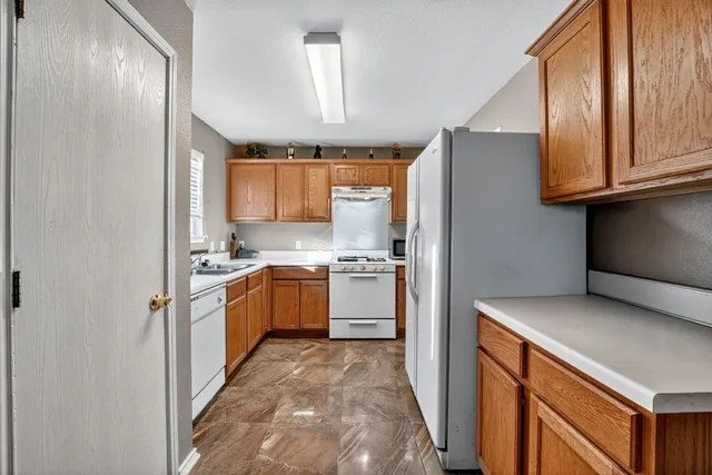 a kitchen with a refrigerator sink and cabinets