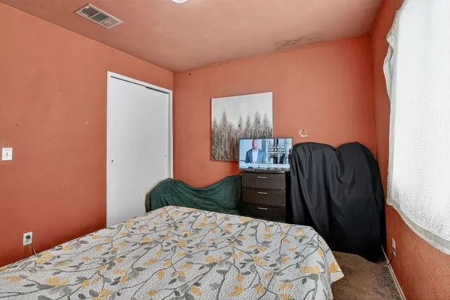 a bedroom with a bed and dresser