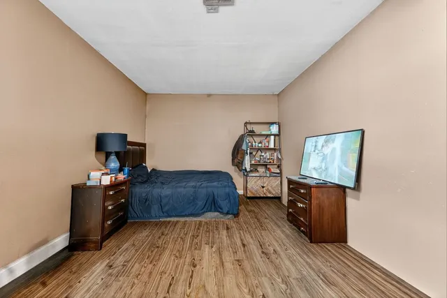 a bedroom with furniture and wooden floor