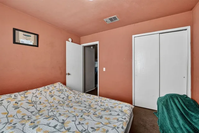 a bedroom with a bed and a dresser