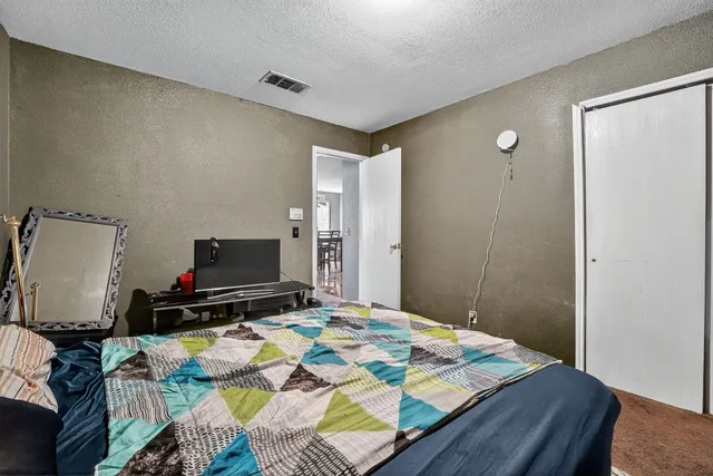 a bedroom with a bed and a flat screen tv