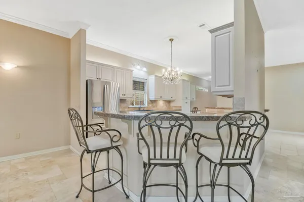 a kitchen with granite countertop white cabinets white stainless steel appliances with a sink and dishwasher