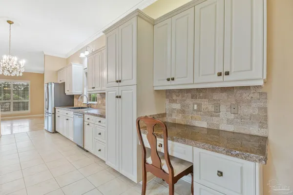 a kitchen with stainless steel appliances granite countertop a stove top oven a sink dishwasher and a refrigerator with wooden floor
