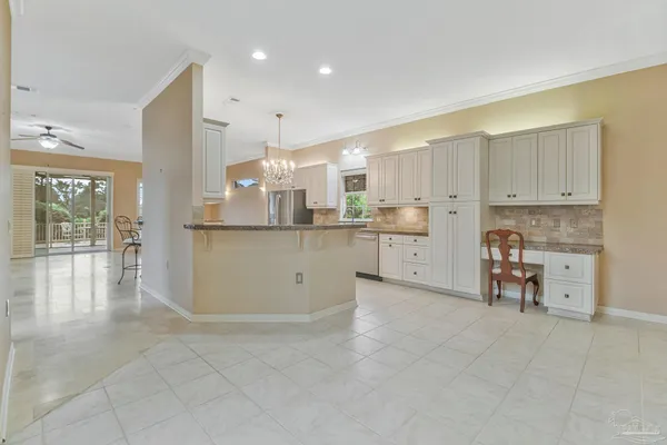 a large kitchen with kitchen island granite countertop a large window and a sink