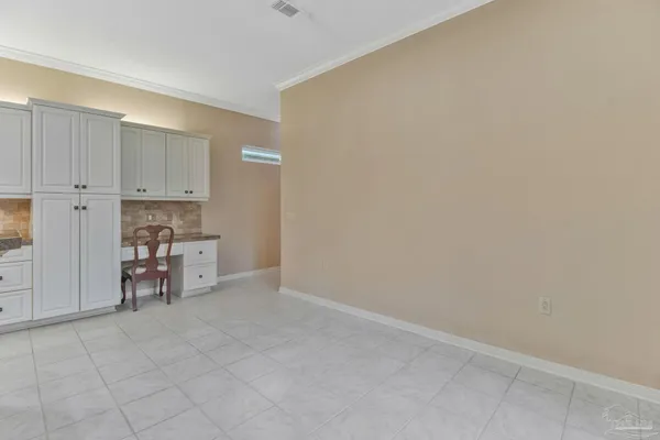 a view of an empty room with a kitchen