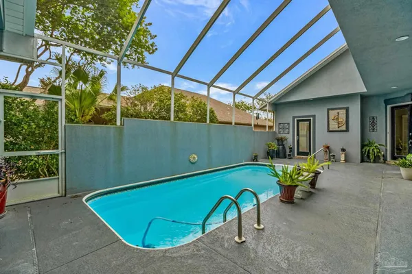 a backyard of a house with table and chairs