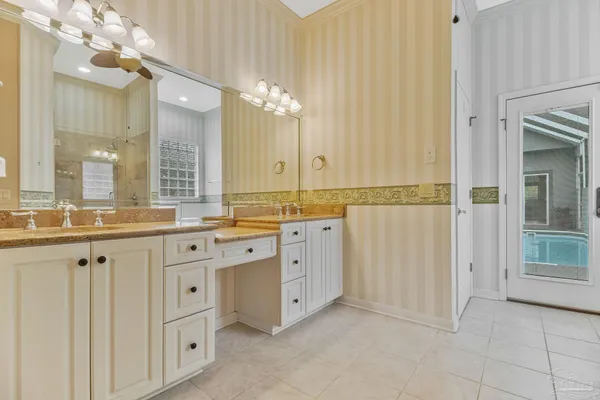 a bathroom with a granite countertop sink a toilet and shower
