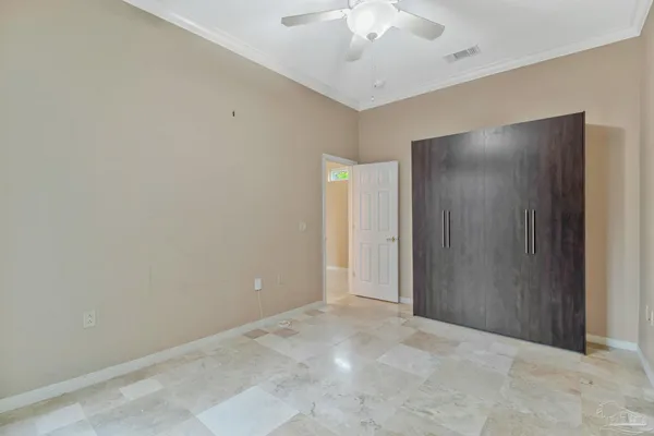 an empty room with windows and air conditioner