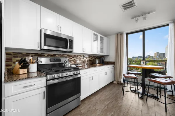 a bath room with a sink a toilet and shower