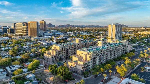 a view of a building with garden and sitting area