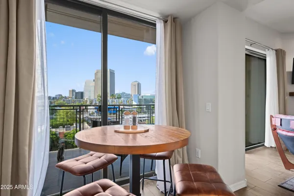 a dining room with furniture a rug and a chandelier