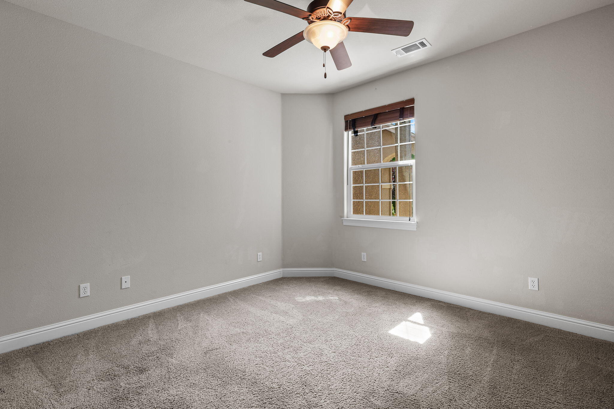 3641 Deuce Way Redding, CA 96002 - Photo 17 of 31 an empty room with a window and a fan