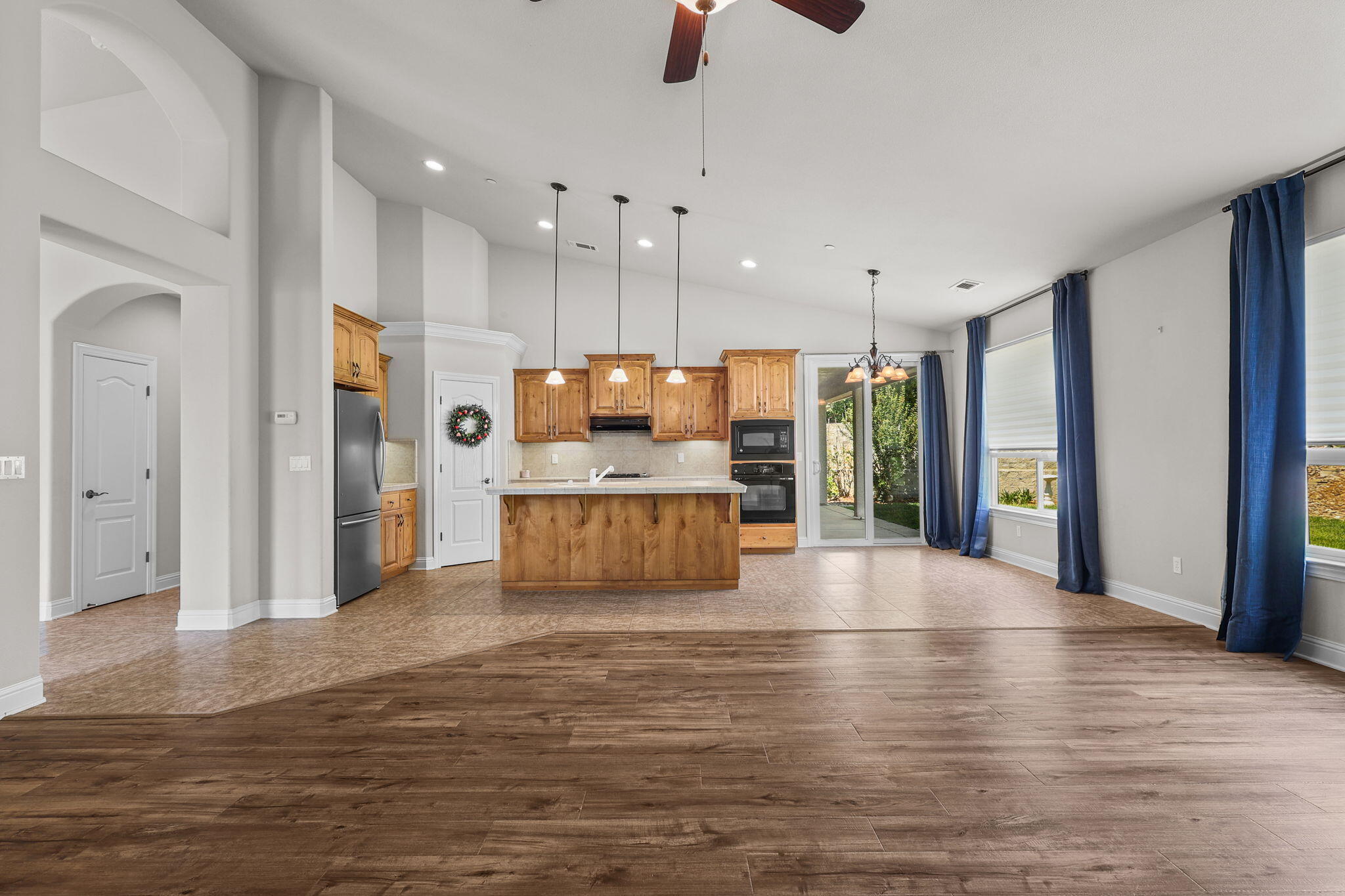 3641 Deuce Way Redding, CA 96002 - Photo 9 of 31 a large kitchen with stainless steel appliances kitchen island a large counter top and a wooden floors