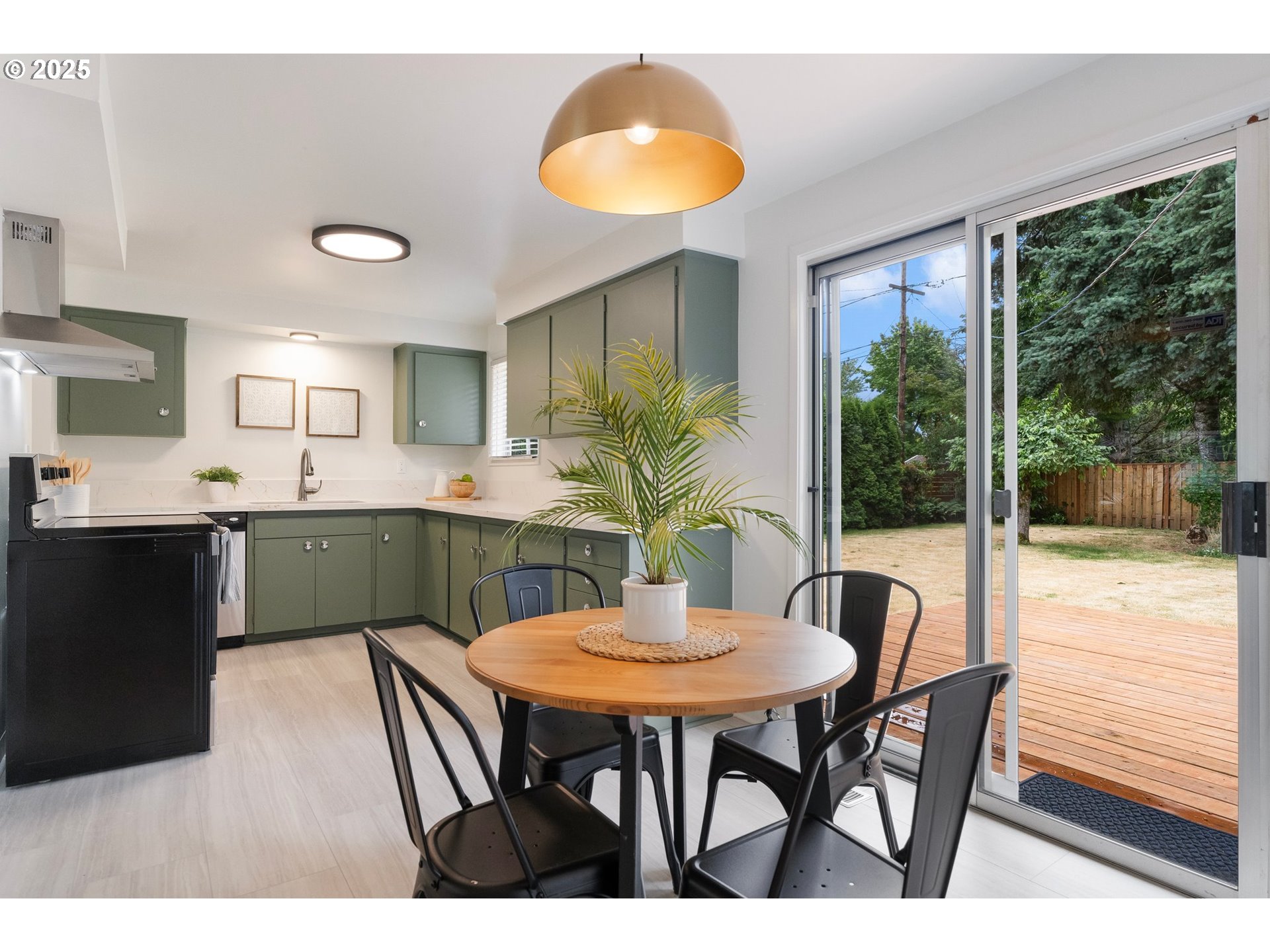 165 Northeast 167th Place Portland, OR 97230 - Photo 11 of 32 a kitchen with kitchen island a table and chairs