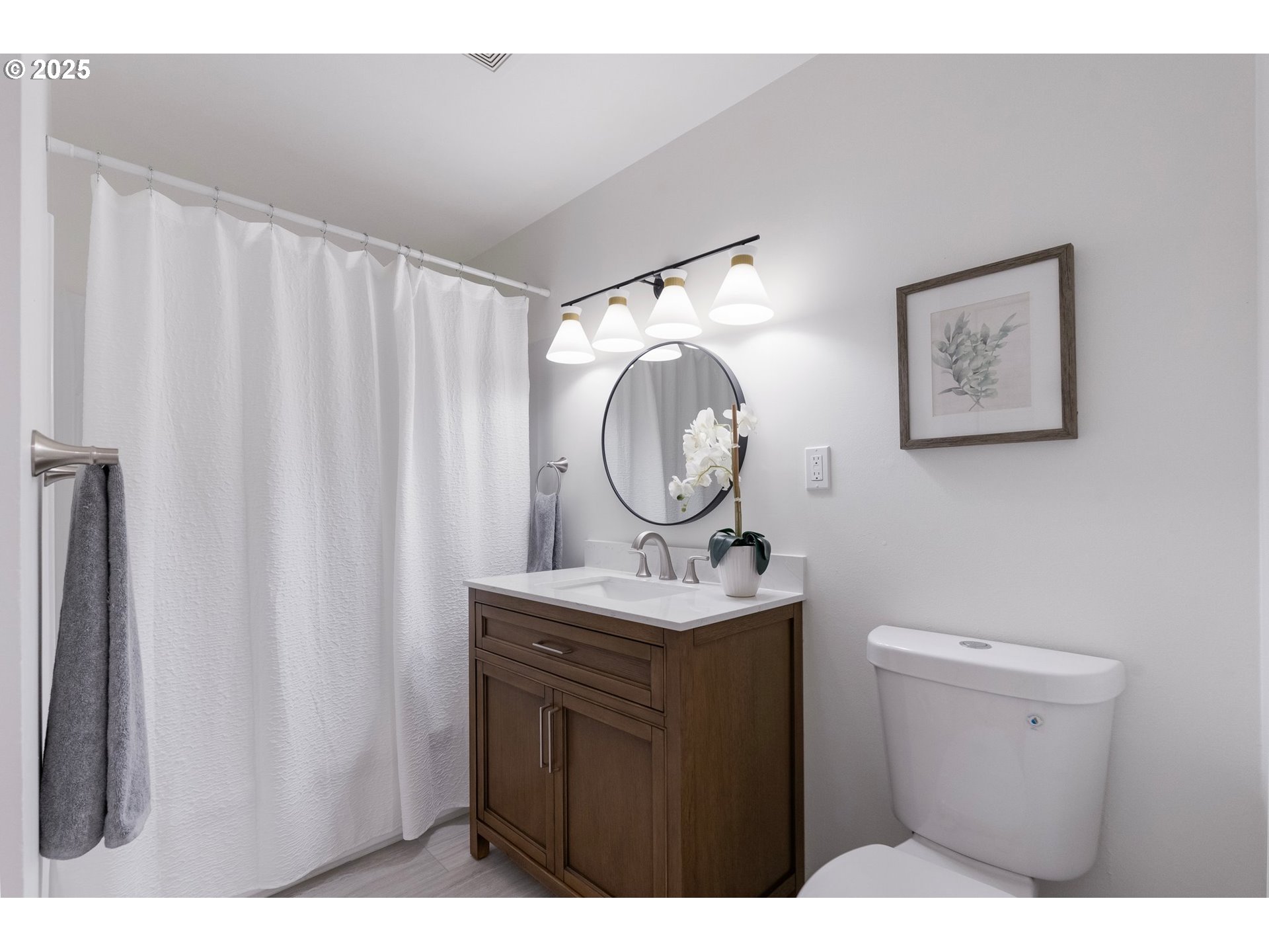 165 Northeast 167th Place Portland, OR 97230 - Photo 18 of 32 a bathroom with a toilet a sink a mirror and a window