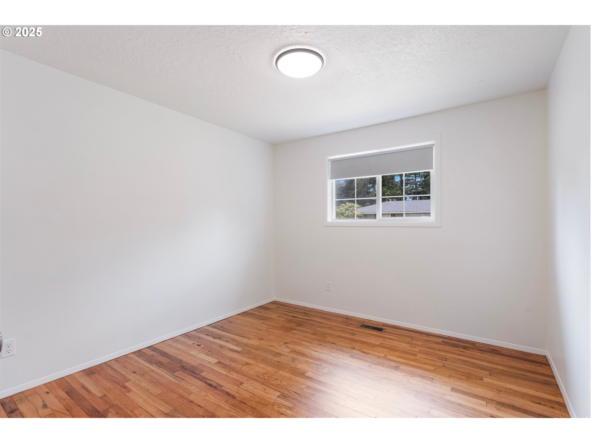 165 Northeast 167th Place Portland, OR 97230 - Photo 24 of 32 a view of empty room with wooden floor
