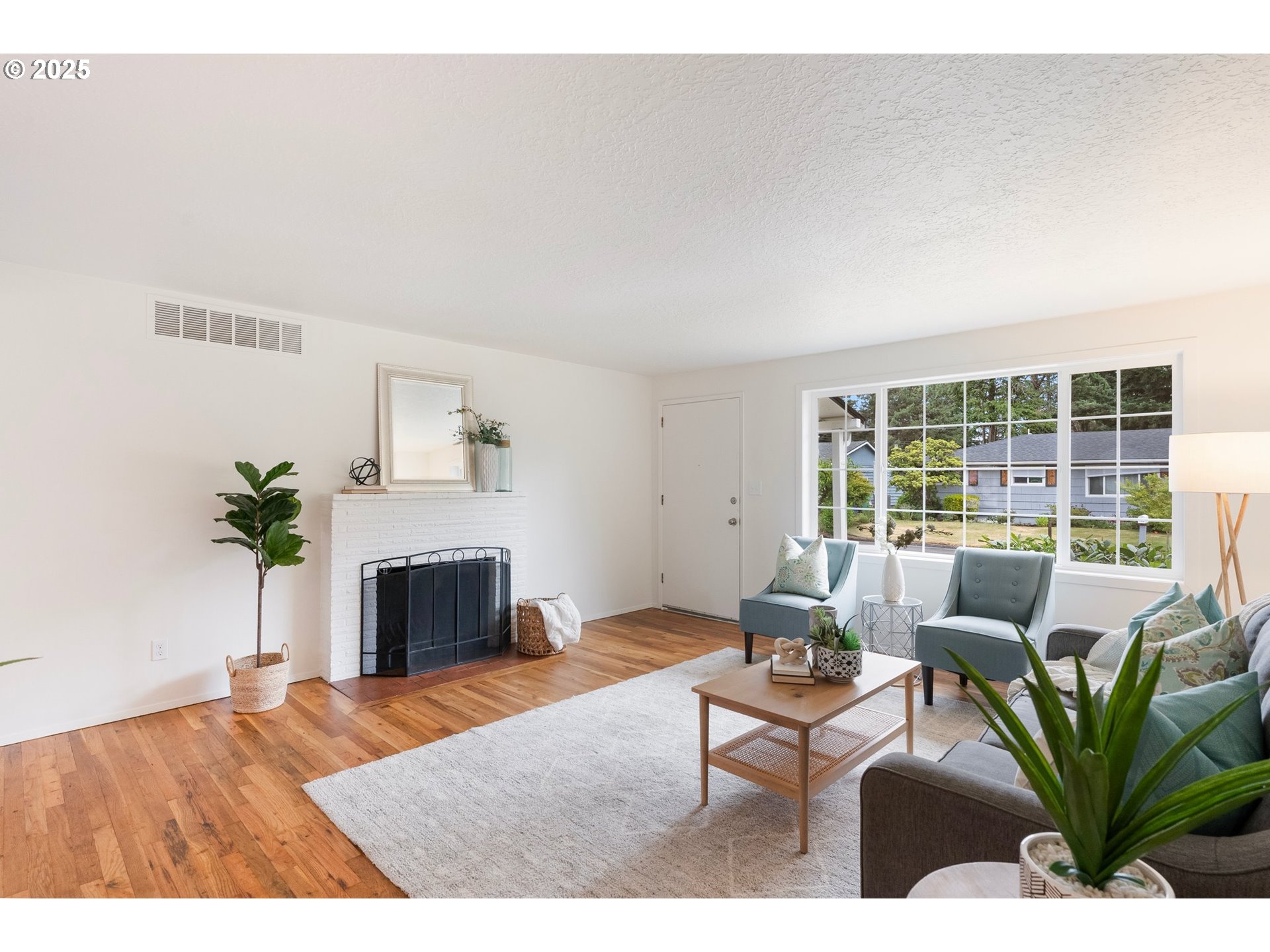 165 Northeast 167th Place Portland, OR 97230 - Photo 3 of 32 a living room with furniture a fireplace and a potted plant