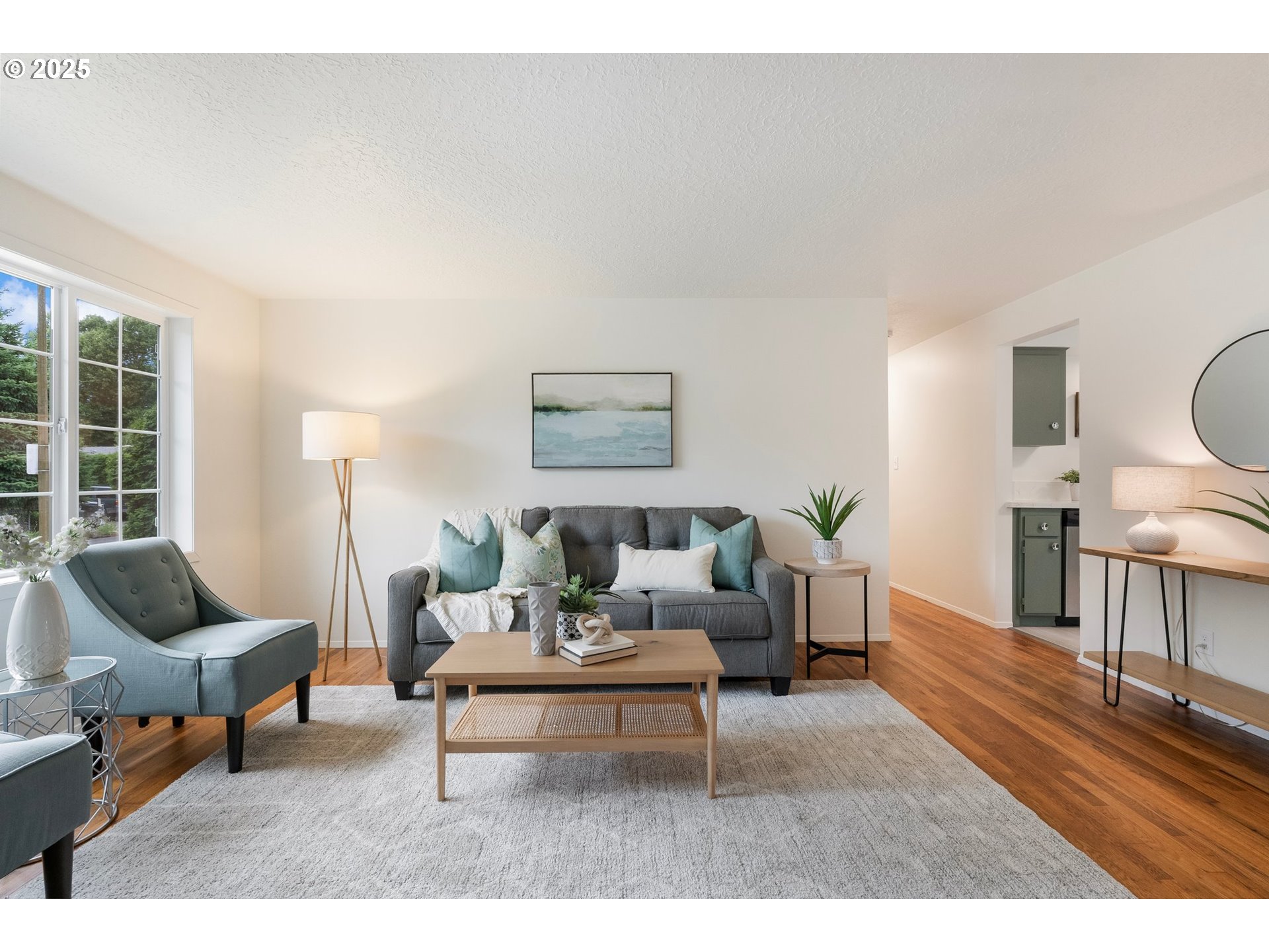165 Northeast 167th Place Portland, OR 97230 - Photo 5 of 32 a living room with furniture and a dining table with wooden floor