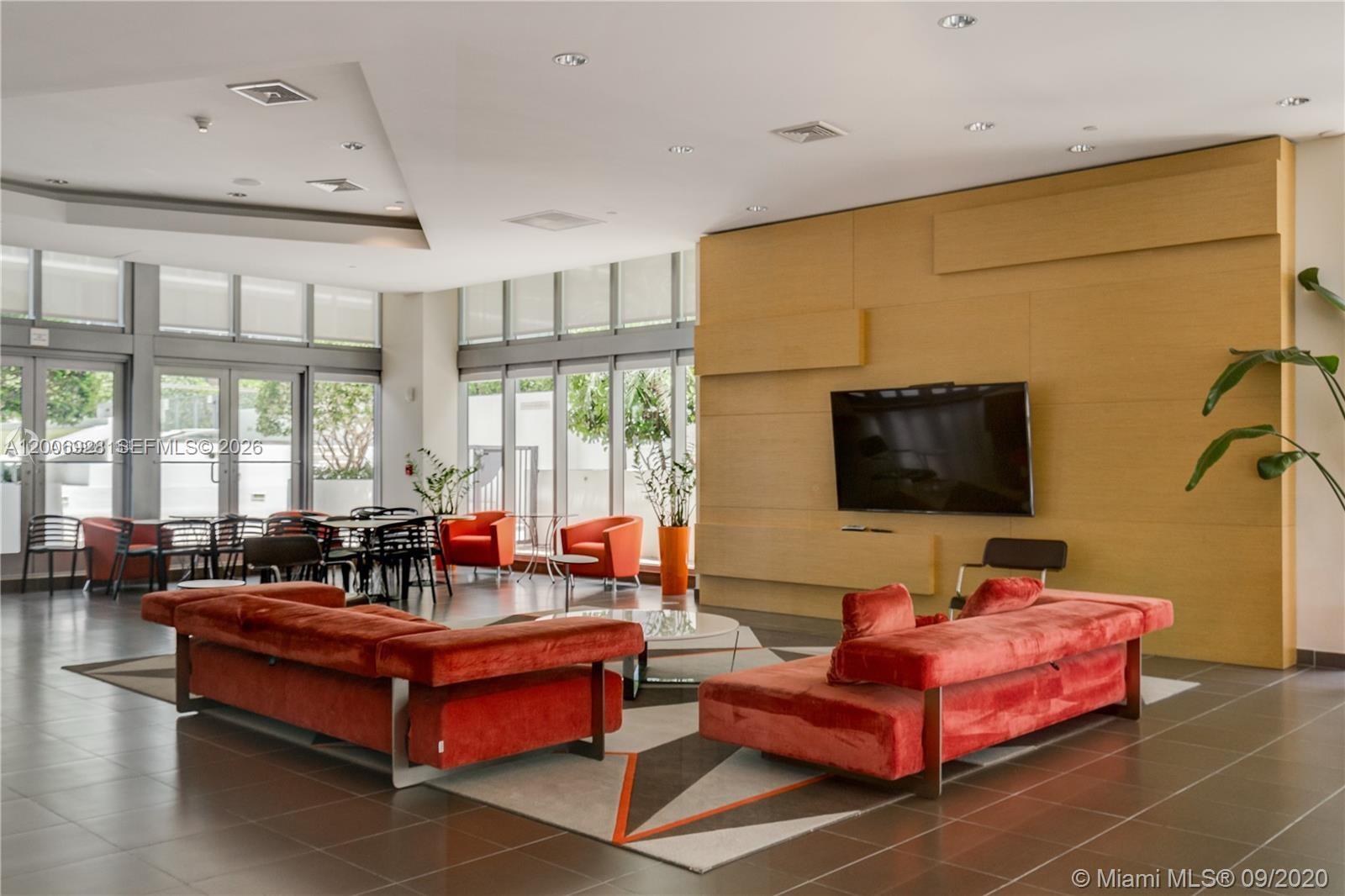 79 Southwest 12th Street, Unit 1903 Miami, FL 33130 - Photo 25 of 25 a living room with furniture and a flat screen tv