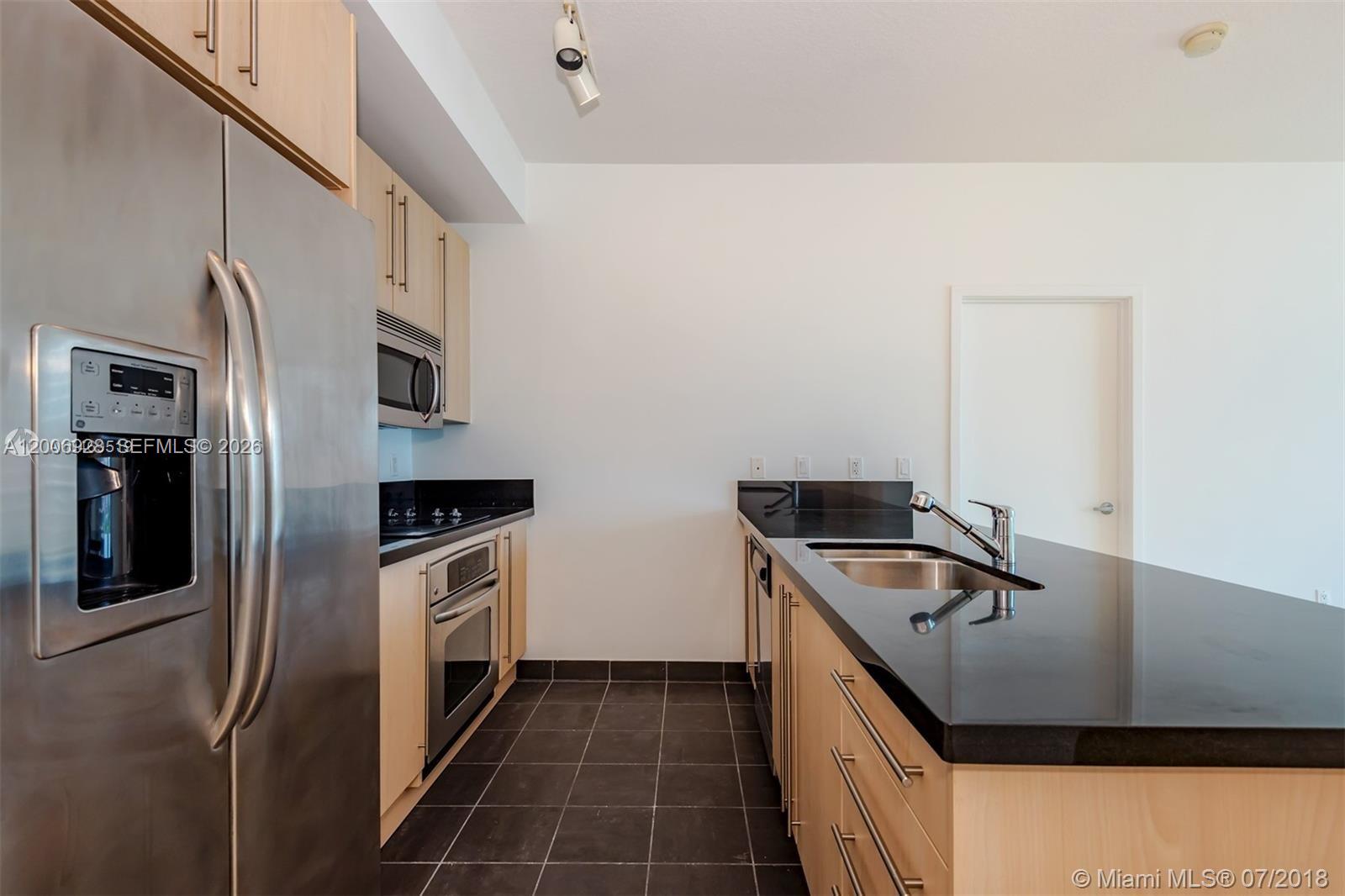 79 Southwest 12th Street, Unit 1903 Miami, FL 33130 - Photo 3 of 25 a kitchen that has a sink and a stove