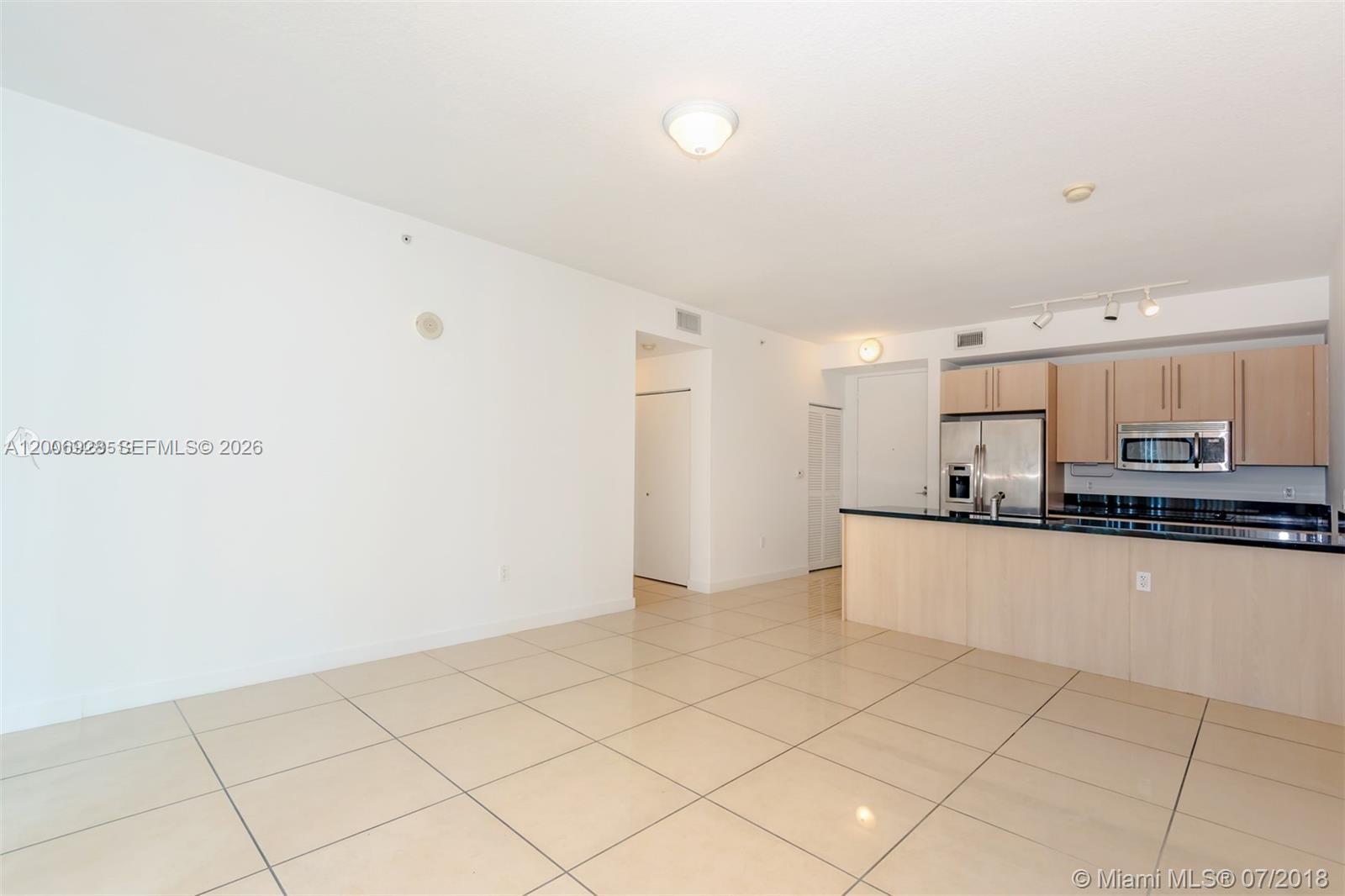 79 Southwest 12th Street, Unit 1903 Miami, FL 33130 - Photo 4 of 25 a large white kitchen with a sink
