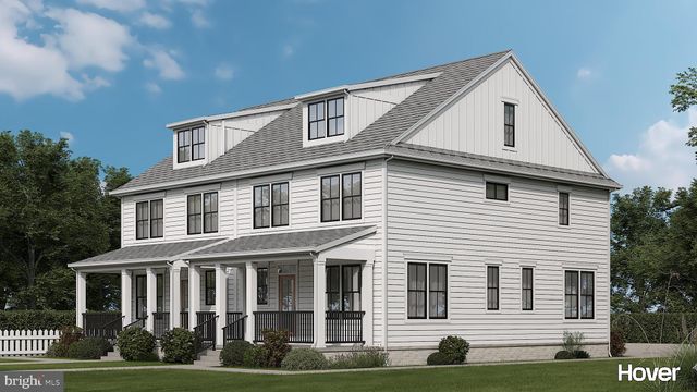 a view of a white house with large windows and a yard