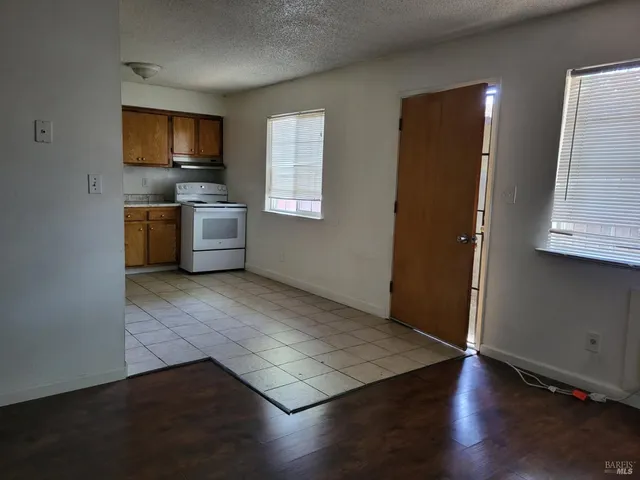 an empty room with wooden floor and a window
